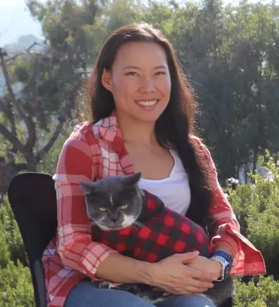 Laura Chan outside with grey cat